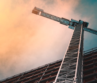 low angle photography of gray tower crane