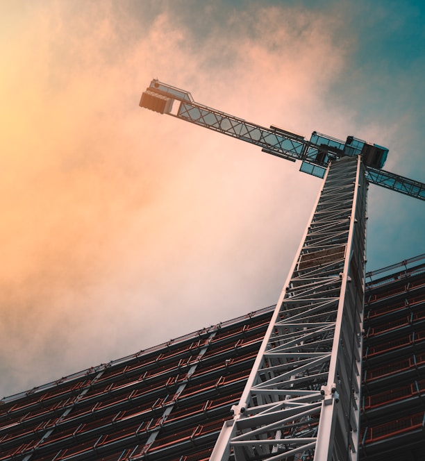 low angle photography of gray tower crane