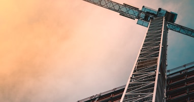 low angle photography of gray tower crane