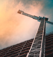 low angle photography of gray tower crane