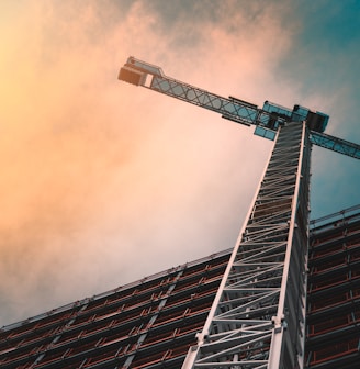 low angle photography of gray tower crane