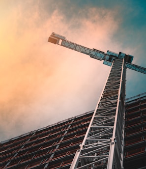 low angle photography of gray tower crane