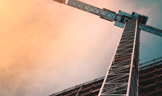 low angle photography of gray tower crane