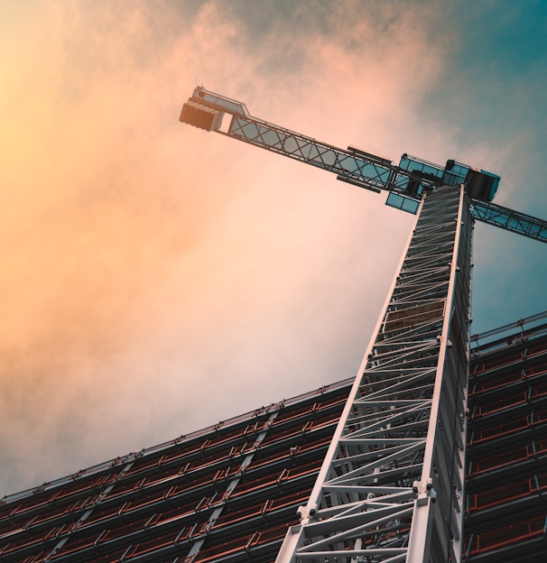 low angle photography of gray tower crane