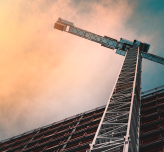 low angle photography of gray tower crane