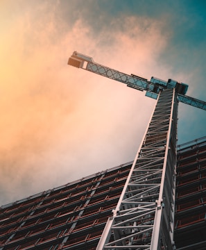 low angle photography of gray tower crane