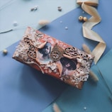 A small, portable music box with a charming hand-painted floral design.