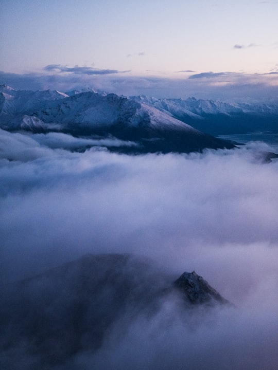 aerial photo of sea of clouds and mountain in Roys Peak New Zealand