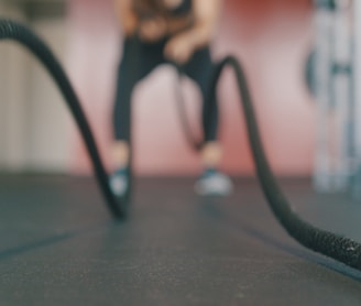 person holding black exercise rope