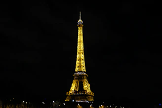 The Eiffel Tower glowing at sunset with a lively Parisian street in the foreground.