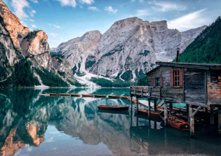 grey wooden cabin near body of water