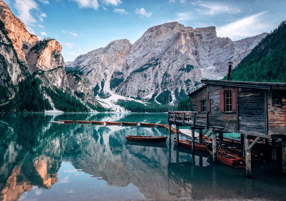 grey wooden cabin near body of water