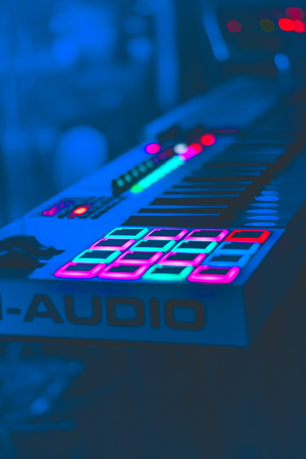 selective focus photo of lighted white electronic keyboard