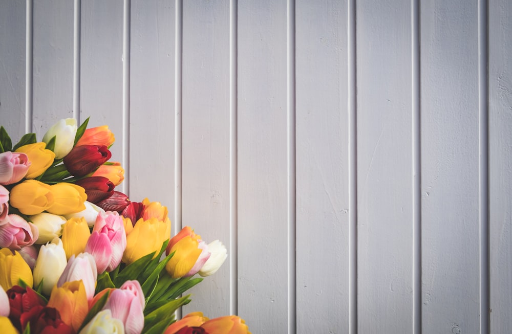 assorted-color flower arrangement near wall