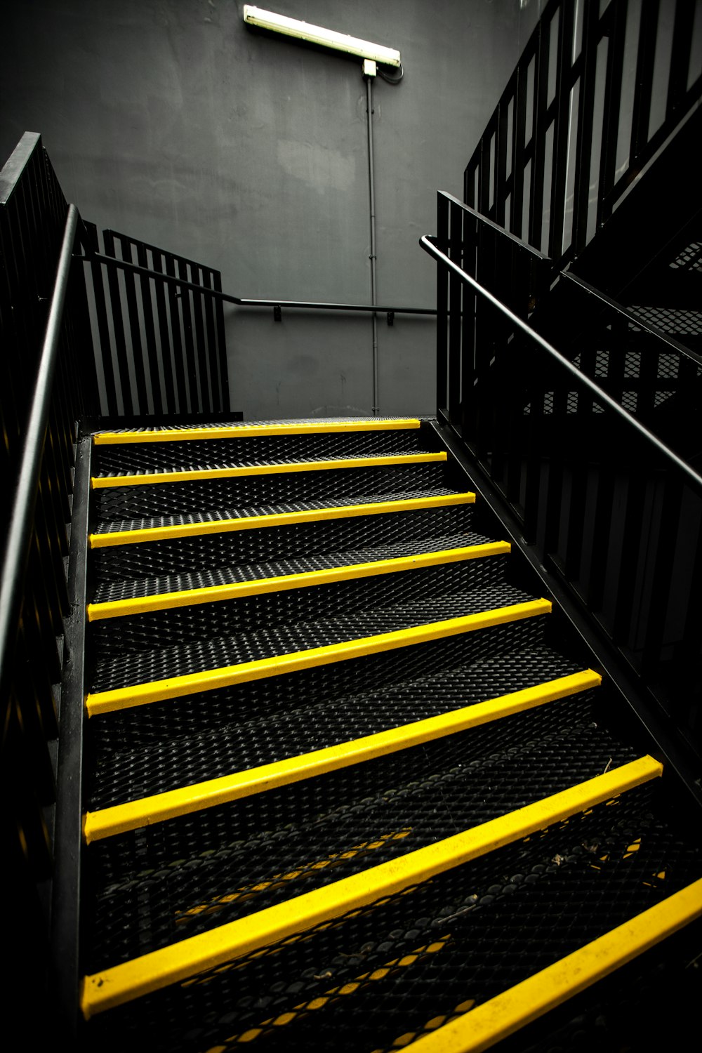 black metal stairs beside wall