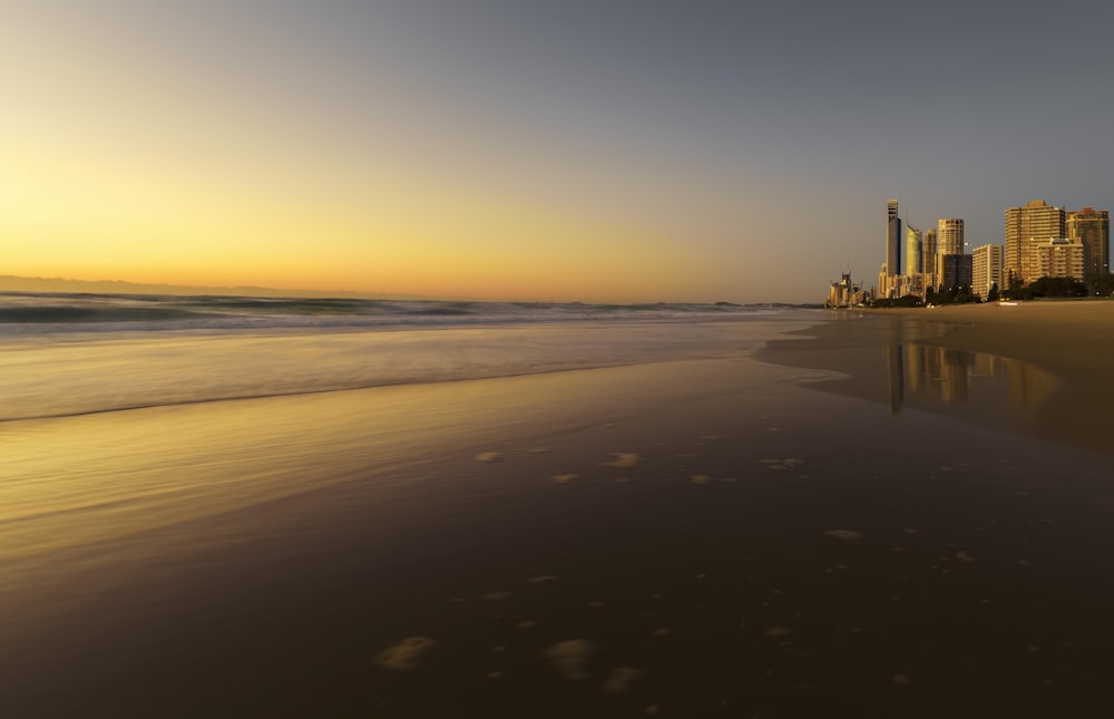 high-rise building beside seashore during golden hour