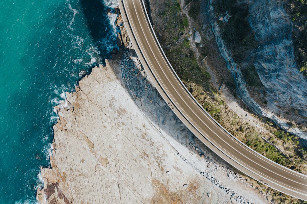 aerial view of road beside body of water