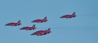 five red-and-black fighter jets