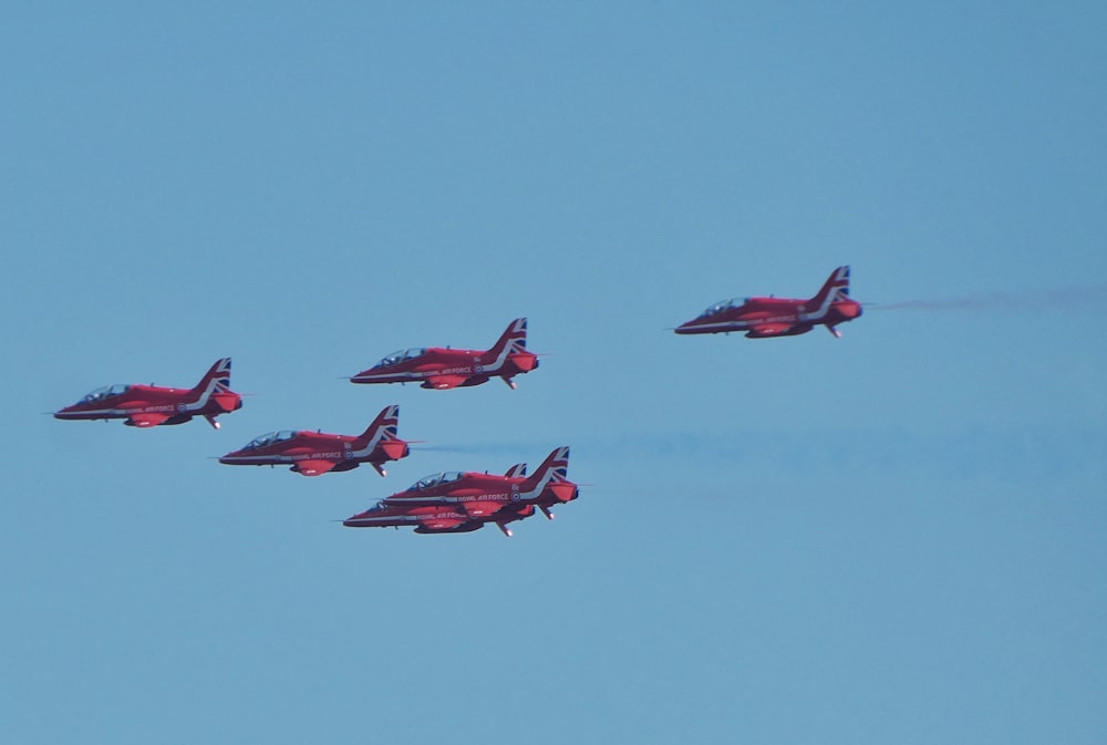 five red-and-black fighter jets