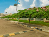 Clean village street with new sanitation facilities and smiling residents.
