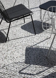 black metal framed padded chair on floor
