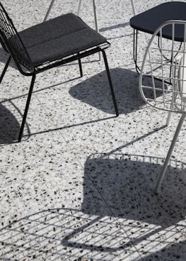 black metal framed padded chair on floor