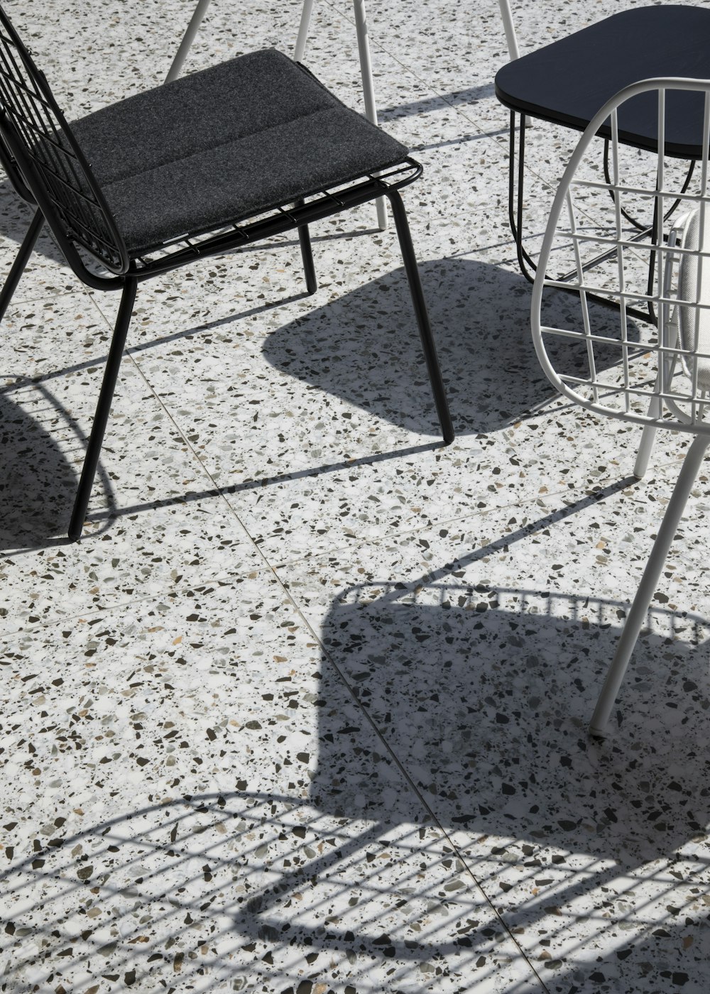 black metal framed padded chair on floor