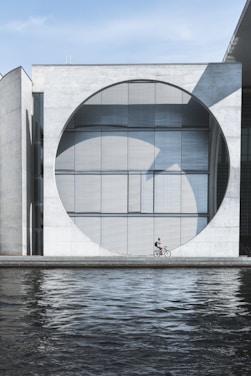 person riding on bike near water