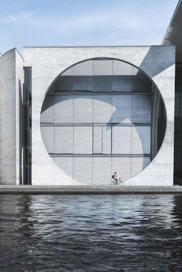 person riding on bike near water