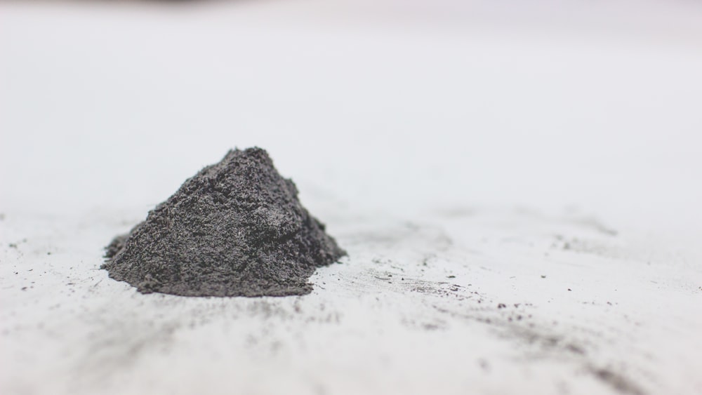 a pile of dirt sitting on top of a white surface