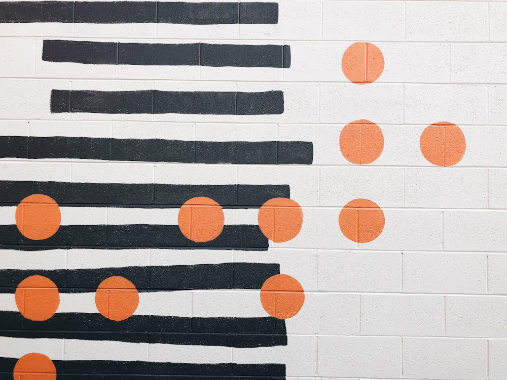 una pared blanca con puntos naranjas pintados en ella