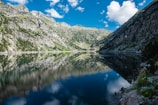 A tranquil mountain landscape with a clear blue sky.