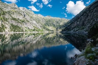 A tranquil landscape featuring mountains and a clear sky.
