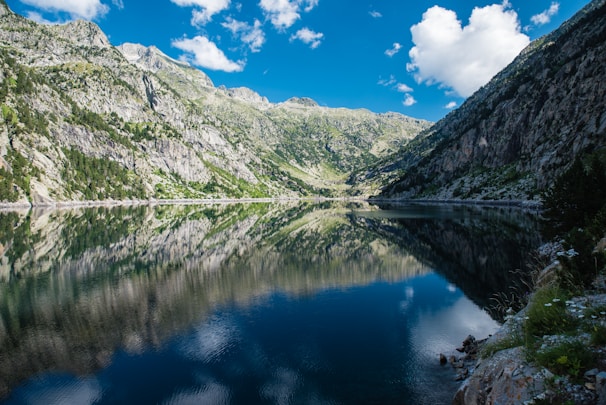 A tranquil landscape featuring mountains and a clear sky.