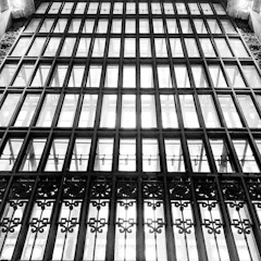 Wide shot of a large steel window with intricate metalwork and clear glass.