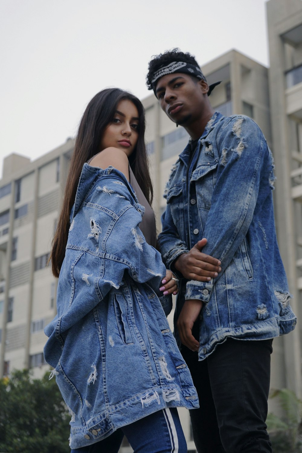 couple wearing distress denim jackets