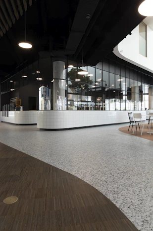 Commercial office interior with stylish flooring and modern ceiling design reflecting spaces by navlin's turnkey solutions.