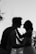 silhouette grayscale photo of man and woman attempting to kiss