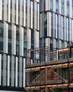 Architectural detail of a sustainable building facade blending glass and natural materials.