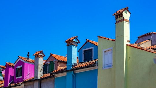 several multicolored concrete houses in Burano Italy