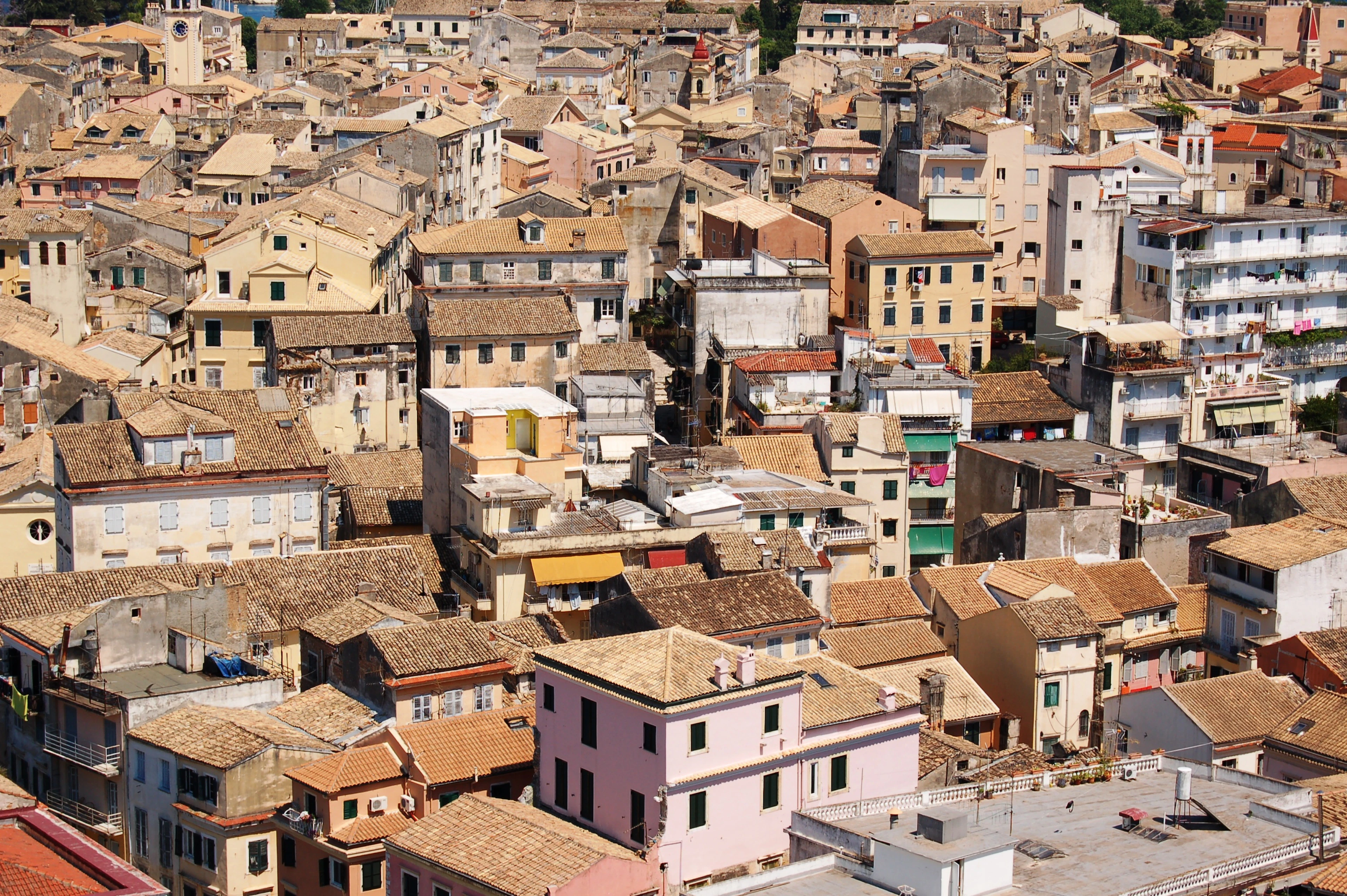 The tiled rooftops of Corfu Town packed together above the old streets, shuttered windows on every facade
