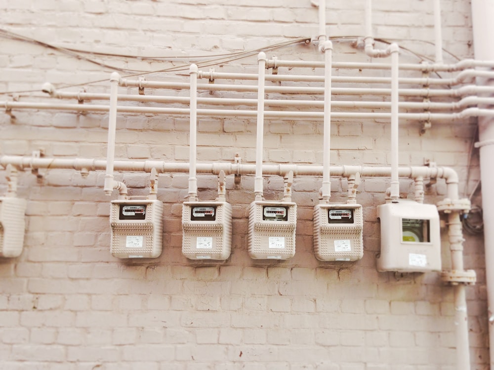 minimalist photography of beige painted electrical boxes