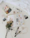 A cozy flat lay of a faith-filled journal surrounded by delicate watercolor flowers and a soft knit blanket.