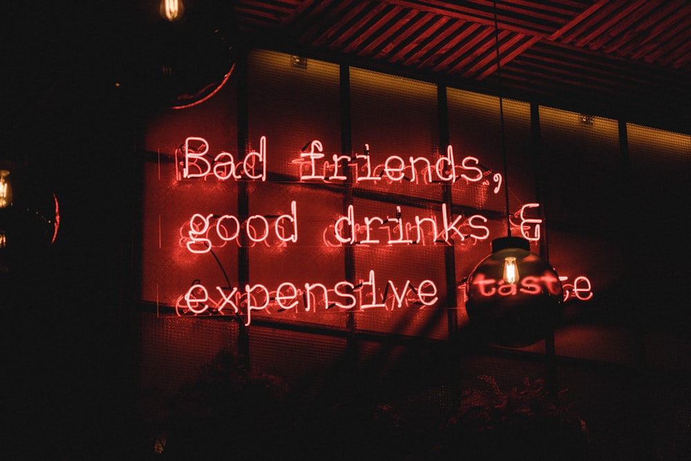 bad friends, good drinks & expensive taste neon sign on wall