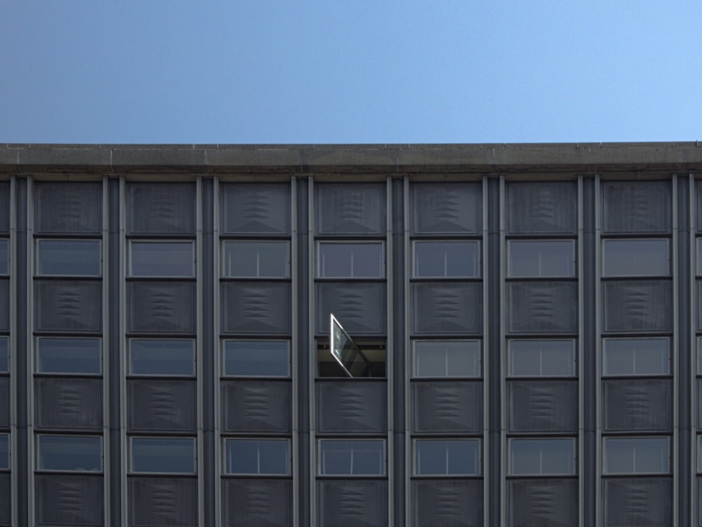 building window opened under clear blue sky