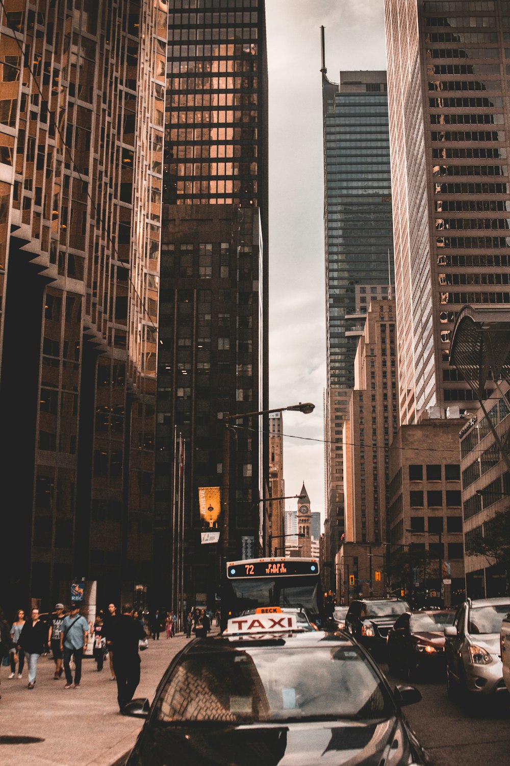 black taxi and high rise buildings during daytime