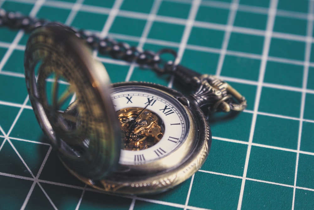 silver-colored pocket watch