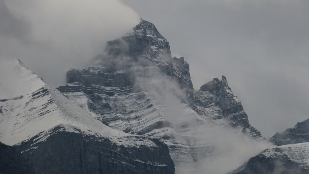 snow-covered mountain under cloudy sky