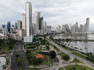 A modern city skyline with green spaces and smart technology elements.