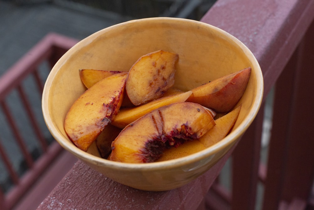 sliced fruits in white ceramic bowl